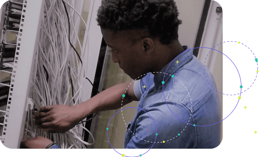Network technician connecting cables in a server rack